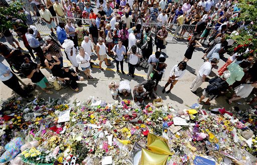 People pay respects outside Emanuel A.M.E. Church during a worship service, Sunday, June 21, 2015, in Charleston, S.C., four days after a mass shooting at the church claimed the lives of its pastor and eight others. (Paul Zoeller/The Post And Courier via AP)