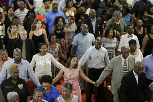 Parishioners sing at the Emanuel A.M.E. Church Sunday, June 21, 2015, in Charleston, S.C., four days after a mass shooting that claimed the lives of it's pastor and eight others. (AP Photo/David Goldman, Pool)